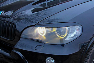 BMW X5 E70 - Uzlikas (skropstas) uz priekšējiem lukturiem